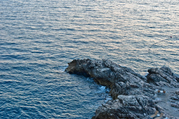 Finger shaped rock in the Croatian ocean used for sunbathing