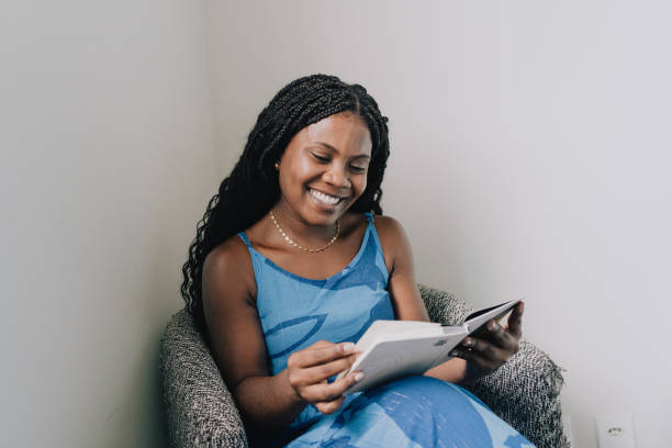 Woman sitting in an armchair reading a book