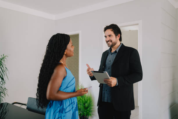 istock Real estate agent visiting a female homeowner 2190603402