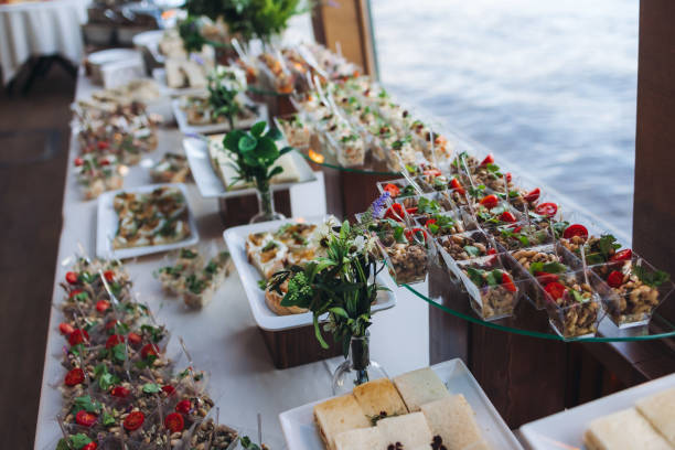 istock Catering table, beautifully decorated banquet with variety different food snacks appetizers on christmas corporate birthday party event or wedding celebration, canape, salad, delicatessen setting 2190603798