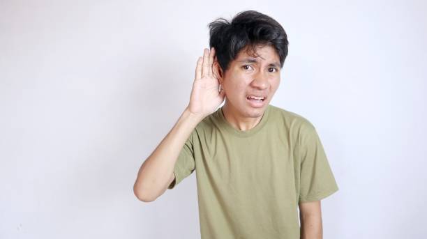 istock Young Asian man gesturing as if he didn't hear something, or trying to listen to something that doesn't sound too loud 2190605003