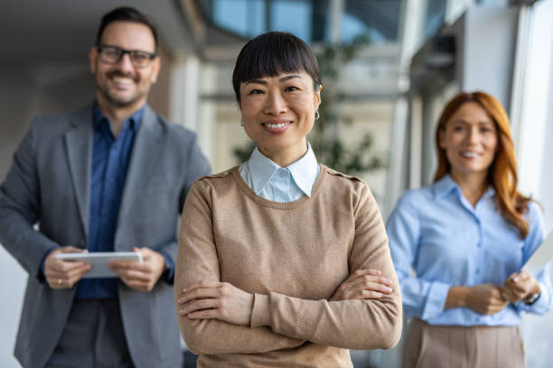 istock Asian business mentor leading diverse team in office 2190605326