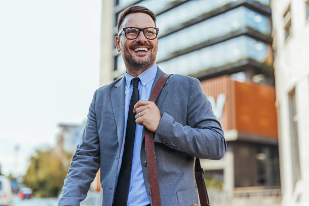 istock Confident Businessman Walking Outside Modern Office Building 2190606541