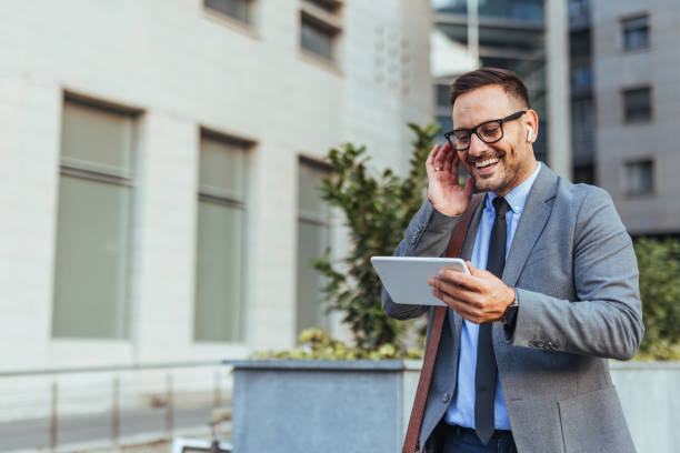 istock Businessman Smiling During Outdoor Video Call on Tablet 2190606549