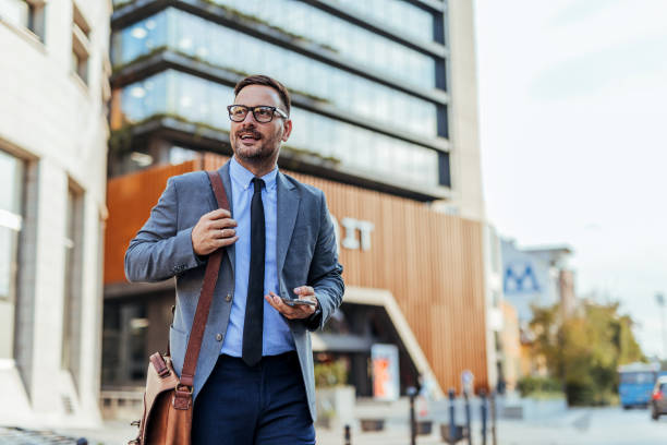 istock Confident Businessman Walking Outside Modern Office Building 2190606557