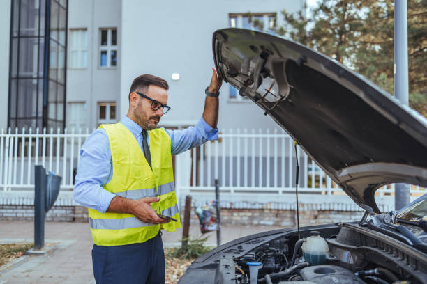 istock Professional Mechanic Inspecting Car Engine in Urban Setting 2190606581