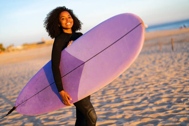 istock Joyful Black Female Surfer With Board on Beach 2190607281