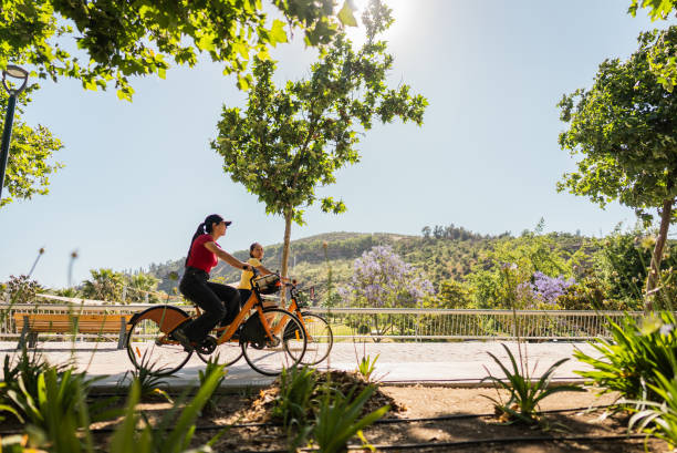 Friends cycling and talking on the public park