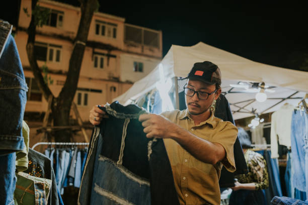 istock Asian guy is choosing his favorite jacket. 2190611572