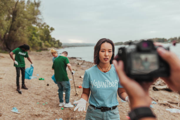 istock Volunteer talking about cleaning the polluted river beach 2190615678