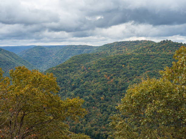 istock Early fall-colored tree-covered mountains at New River Gorge National Park, West Virginia, beneath a sky filled with clouds. 2190616226