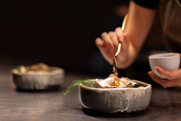 Chef Preparing Plating Fresh Oyster Dishes Putting Garnish