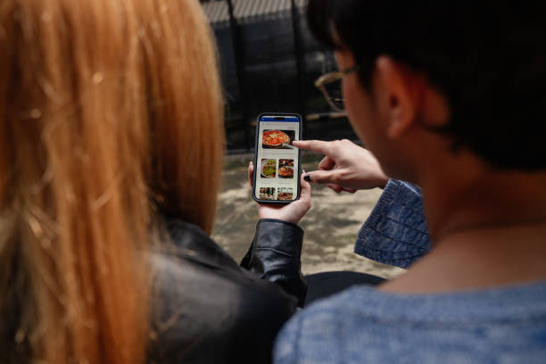 istock Friends choosing from a digital menu at a cafe 2190619613