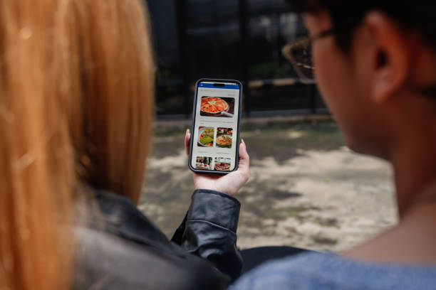 istock Friends choosing from a digital menu at a cafe 2190619632