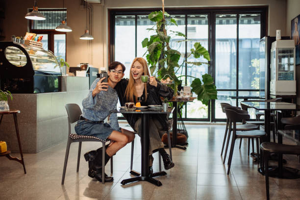 istock Friends taking selfies at cafe 2190619836