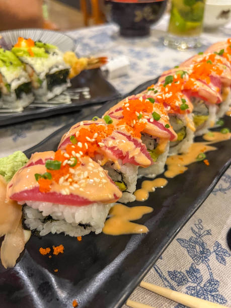 istock Sushi Rolls with Tuna and Avocado on Black Platter 2190620372