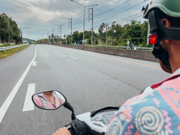 istock Person Riding Scooter on Open Highway 2190620428