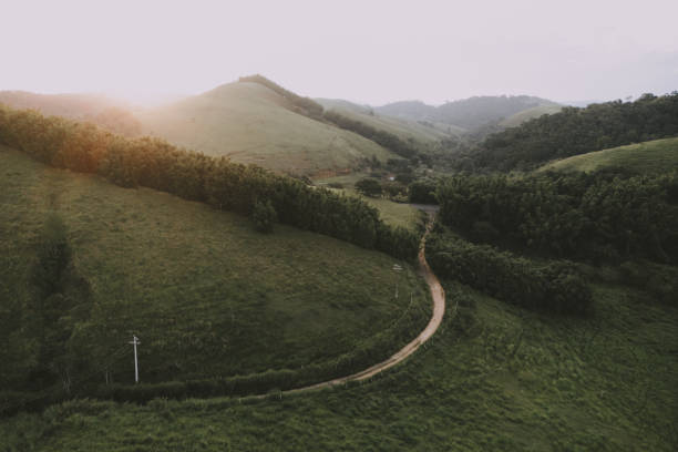 Dirt road in a valley at sunset