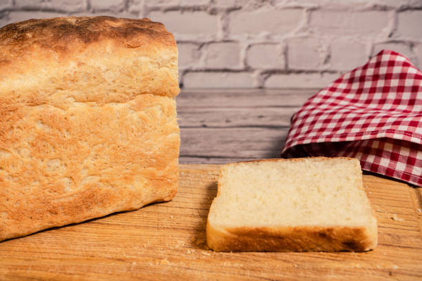 istock White bread loaf on a cutting board next to a freshly cut slice. 2190622876