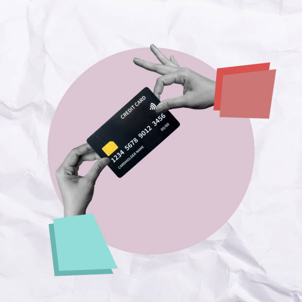 istock A human hand holding a credit card on a colored background 2190623245