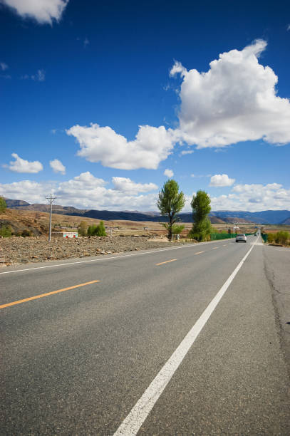 istock A road going straight forward under the white clouds in the sky 2190623302