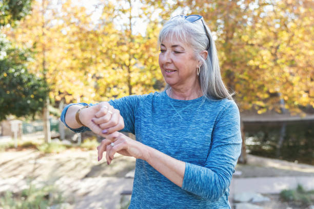 istock Active senior woman looking at her fitness tracker 2190623472