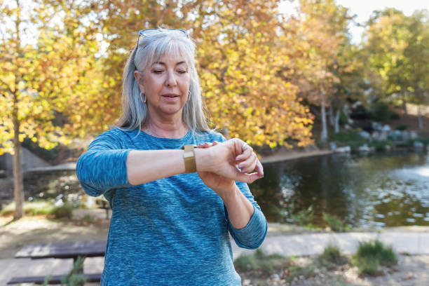 istock Active senior woman looking at her fitness tracker 2190623477