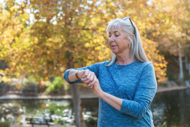 istock Active senior woman looking at her fitness tracker 2190623489