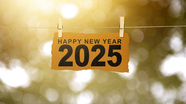istock Text of Happy New Year 2025 written on hanging paper with abstract bokeh light background 2190623607