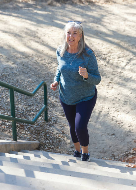 istock Senior woman walking up outdoor steps for exercise 2190623658