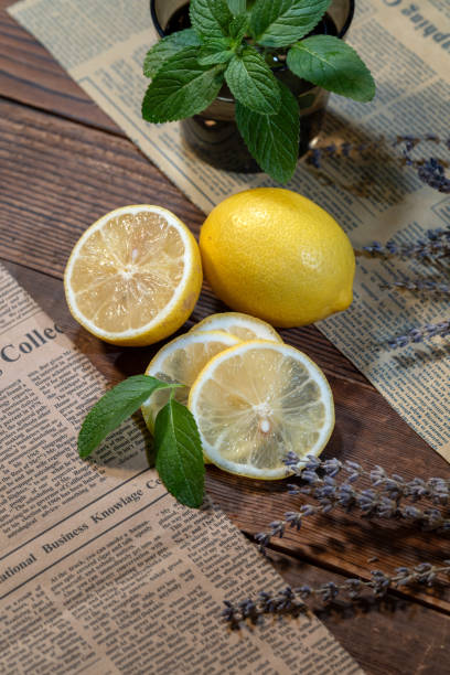 Newspaper props and cut and whole lemons on countertop