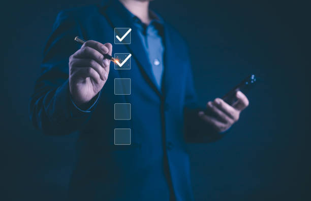 istock Business performance checklist concept, Take an assessment business man, Businessman using smart phone an survey filling form list options business employee security procedures. 2190626361