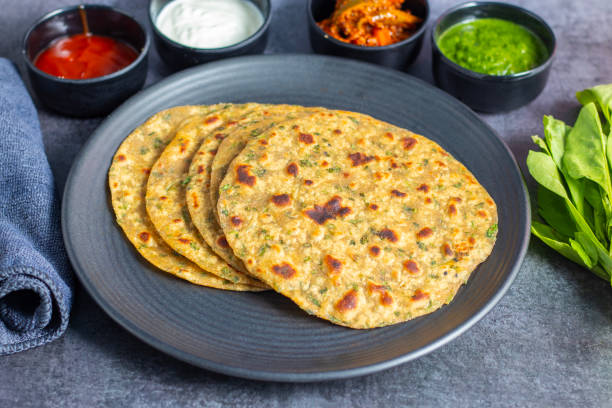 istock Palak paratha is a soft, spinach-filled flatbread, served with creamy, spiced palak paneer—a flavourful spinach and cottage cheese curry. 2190629228