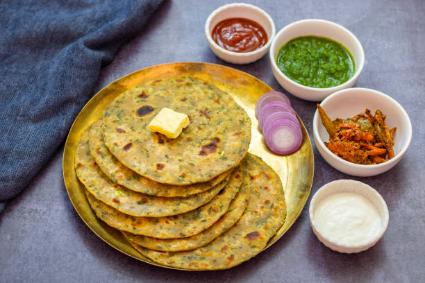 istock Palak paratha is a soft, spinach-filled flatbread, served with creamy, spiced palak paneer—a flavourful spinach and cottage cheese curry. 2190629280
