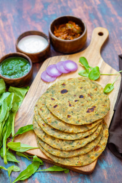 istock Palak paratha is a soft, spinach-filled flatbread, served with creamy, spiced palak paneer—a flavourful spinach and cottage cheese curry. 2190629281