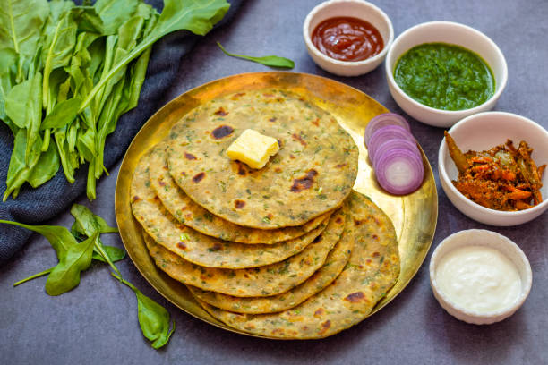 istock Palak paratha is a soft, spinach-filled flatbread, served with creamy, spiced palak paneer—a flavourful spinach and cottage cheese curry. 2190629302