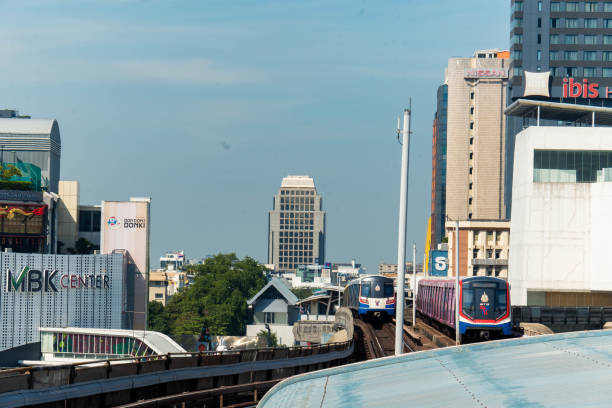 Bangkok, Thailand - 20 11 2025 : Scenic view of a bustling Bangkok cityscape during a late morning. Skytrain traveling, Iconic landmarks MBK and Bangkok Art and Culture Centre.