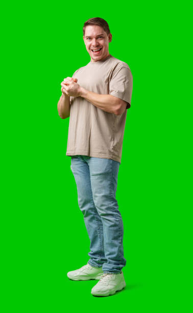 istock A cheerful man with a friendly smile poses against a bright green background 2190634671