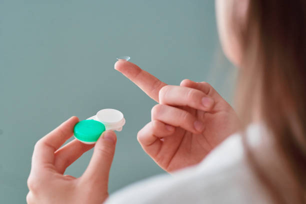 istock Young woman using soft contact lenses instead of glasses for vision correction 2190636352