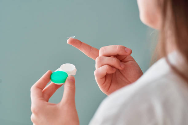 istock Young woman using soft contact lenses instead of glasses for vision correction 2190636360