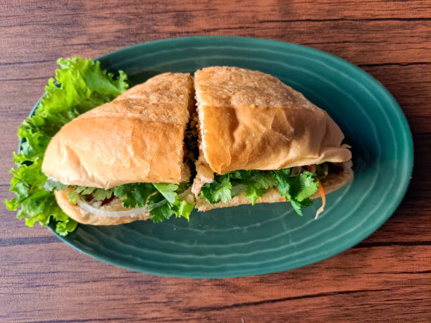 istock Chicken Banh Mi Is A Vietnamese Sandwich Bread Filled with Complementary Vegetables, Pate Sauce, Satay Sauce, Beef Floss and Grilled Chicken Marinated with Lemongrass Seasoning. Vietnam Food Menu. Top View. 2190637251