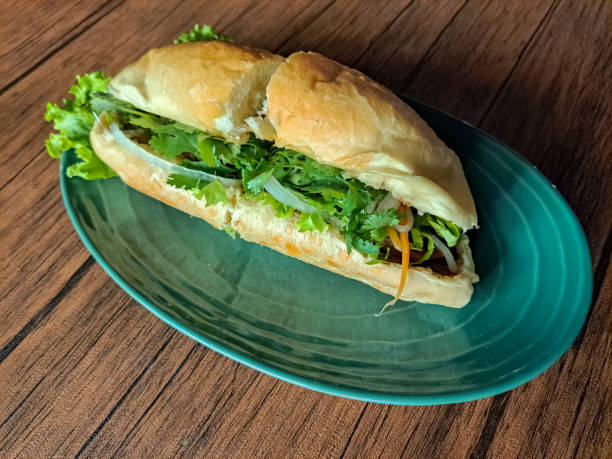 istock Tasty Chicken Banh Mi Is A Vietnamese Sandwich Bread Filled with Complementary Vegetables, Pate Sauce, Satay Sauce, Beef Floss and Grilled Chicken Marinated with Lemongrass Seasoning. Vietnam Food Menu. 2190637340