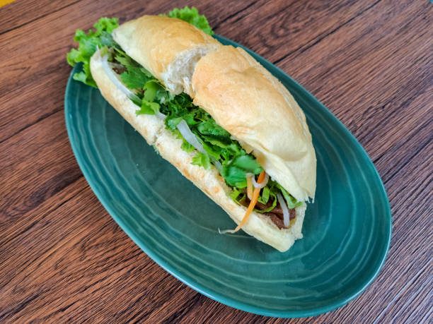 istock Yummy Chicken Banh Mi Is A Vietnamese Sandwich Bread Filled with Complementary Vegetables, Pate Sauce, Satay Sauce, Beef Floss and Grilled Chicken Marinated with Lemongrass Seasoning. Vietnam Food Menu. 2190637401