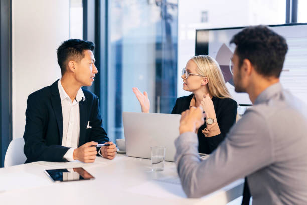 istock Diverse Business Team Engaged in a Dynamic Meeting Discussion in a Modern Office Environment 2190639110