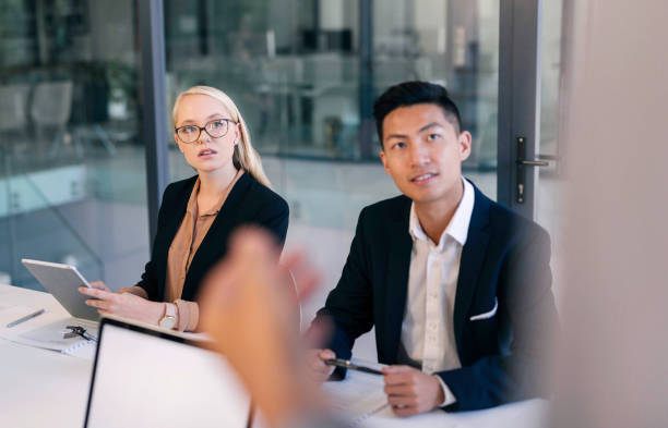 istock Young Professionals Engaging in a Collaborative Business Meeting at a Modern Office Setting 2190639148