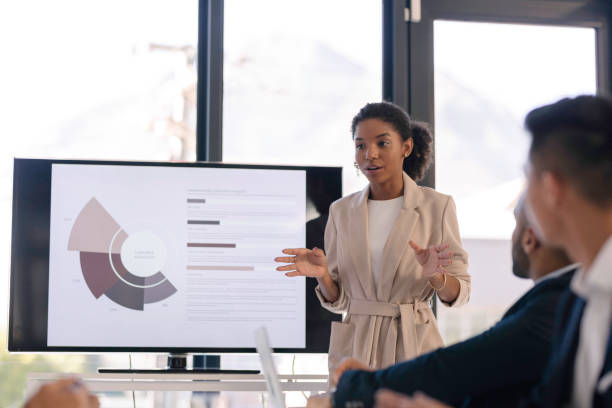istock Young Professional Woman Delivering a Business Presentation in a Modern Office Setting 2190639155