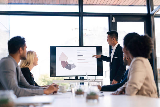 istock Diverse Business Team Engaged in a Professional Presentation in a Modern Office Setting 2190639161