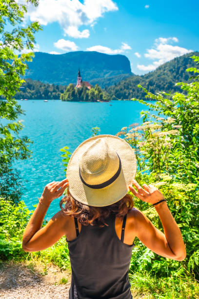 istock Tourist holding her hat while admiring lake bled in slovenia 2190640130
