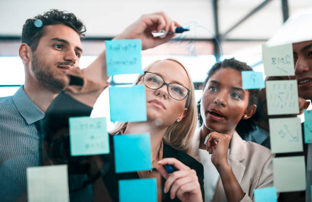 istock Team Collaborating During a Business Strategy Planning Session with Sticky Notes and Discussions 2190640347