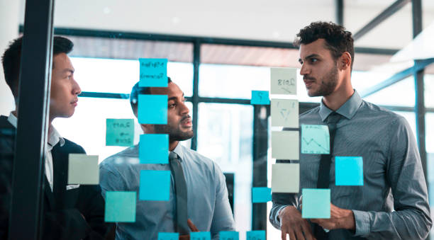 istock Business Team Collaborating In a Modern Office With Planning Notes During a Strategic Meeting 2190640349